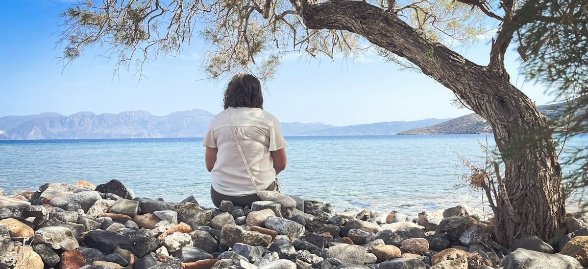 A person sits and enjoys the scenic seaside view