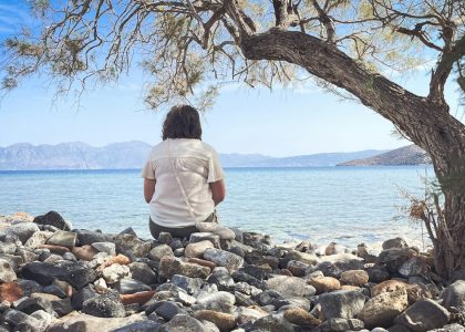A person sits and enjoys the scenic seaside view